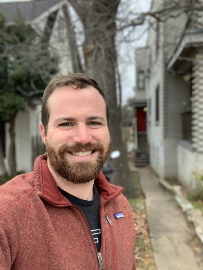 Logan Humphrey in front of his first short-term rental in Fayetteville, Arkansas