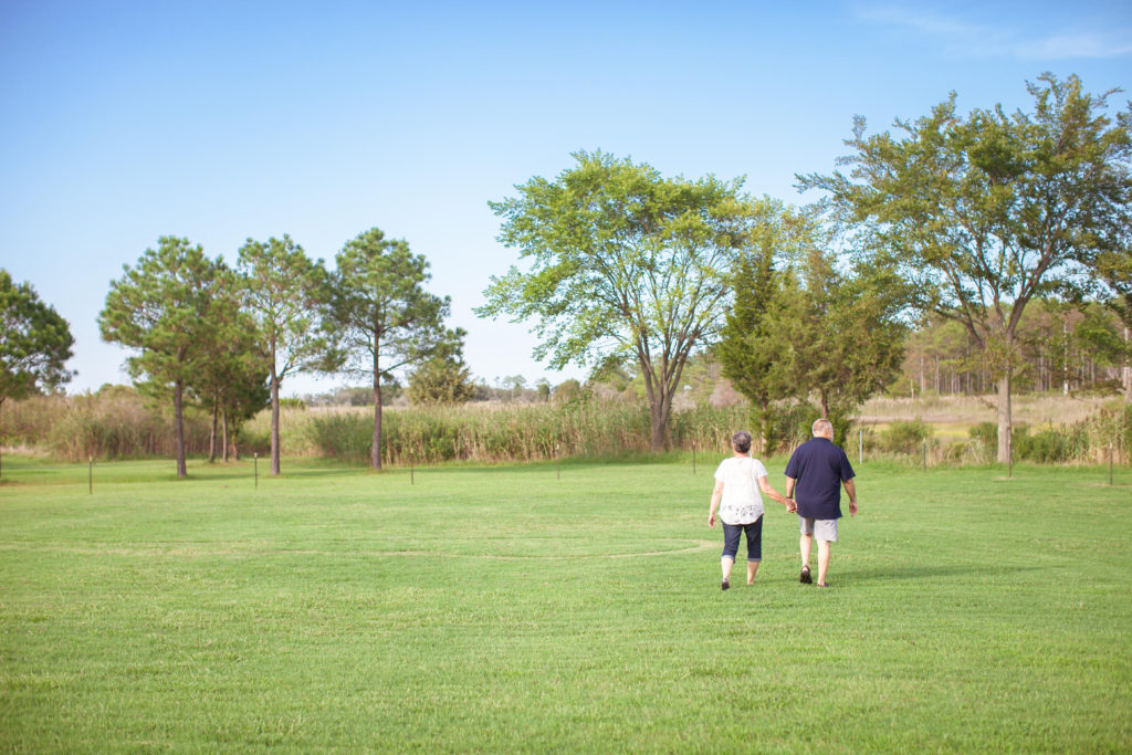 Linda and Ned Popovich walking the grounds of their Hampton Roads vacation rental Casa de Grandview