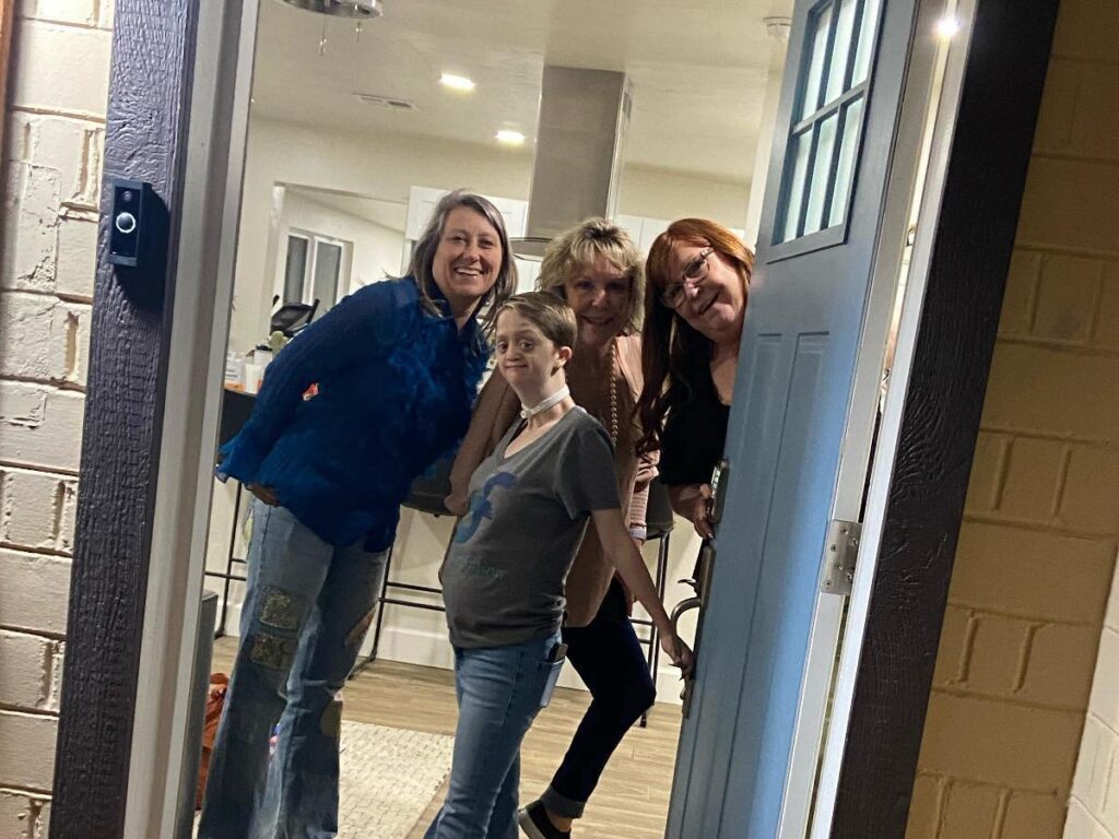 Kellirae poses with her mom and two friends at the front door of Kelsey and Josh's vacation rental, Mulberry Bungalow, in Phoenix, Arizona.